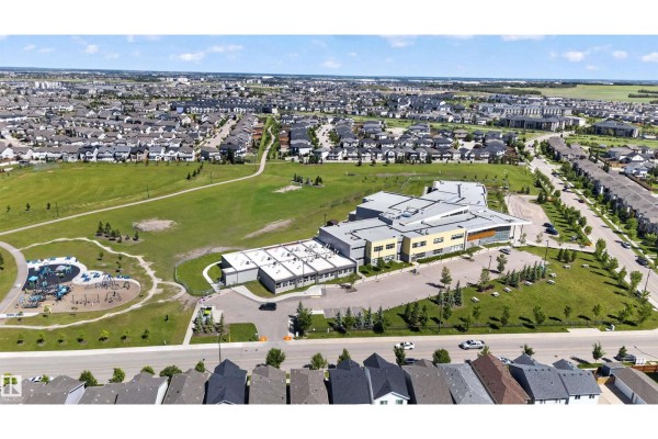 Aerial view of a suburban neighborhood with a school and park. - 5130 Cawsey Bn Sw, Edmonton