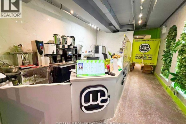 Service counter with beverage dispensers and a menu display in a commercial space. - 514 Yonge Street, Toronto