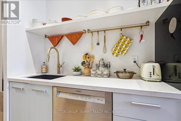 Kitchen with gold faucet, black sink, Bosch dishwasher, toasters, and shelving - 515 - 38 Dan Leckie Way Toronto