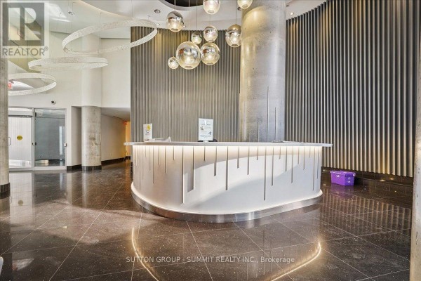 Modern lobby with reception desk, globe lights & ring lights - 515 - 38 Dan Leckie Way Toronto