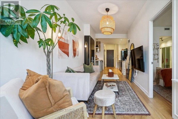 Living room with sectional sofa, plant, and rattan light - 515 - 38 Dan Leckie Way Toronto