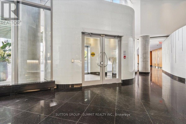 Building hallway with glass doors and tiled walls - 515 - 38 Dan Leckie Way Toronto