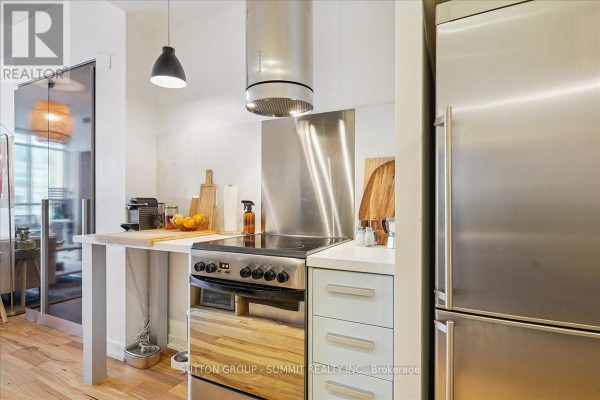 Stainless steel kitchen with refrigerator, range, hood, and pendant light - 515 - 38 Dan Leckie Way Toronto