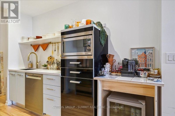 Kitchen with stainless steel dishwasher, gold faucet, built-in microwave, coffee maker, mini-fridge - 515 - 38 Dan Leckie Way Toronto