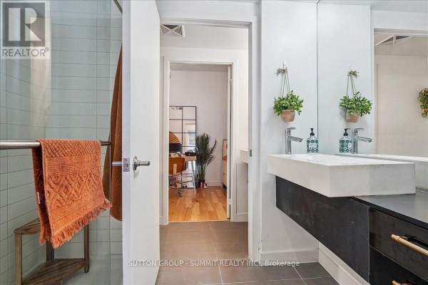 Modern bathroom with double vanity, hanging plants, and view into office - 515 - 38 Dan Leckie Way Toronto