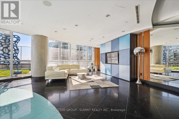 Living room with white sectional sofa, entertainment unit, TV, and large windows - 515 - 38 Dan Leckie Way Toronto