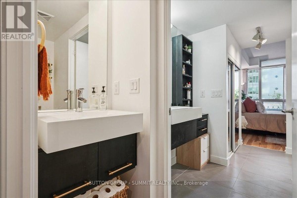 Modern bathroom vanity with vessel sink and floating cabinet, open to bedroom - 515 - 38 Dan Leckie Way Toronto