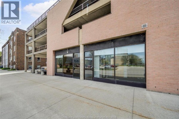 Commercial storefront with large glass windows facing a sidewalk and street. - 515 Riverside Drive West Unit# 104 A, Windsor