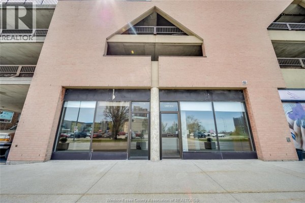 Front view of two commercial units with large glass windows and brick facade. - 515 Riverside Drive West Unit# 104 A, Windsor