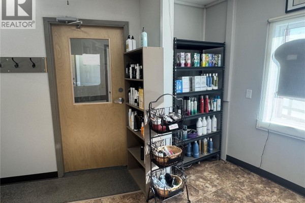 Entryway with shelving for hair products and coat hooks. - 516 La Ronge Avenue, La Ronge