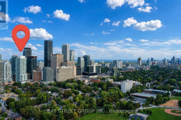 View of Toronto high-rise buildings, featuring modern architecture and city streets below. - 517 - 33 Helendale Avenue, Toronto
