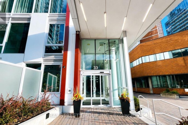 Expansive view of Toronto's urban landscape, showcasing buildings, trees, and a park. - 517 - 33 Helendale Avenue, Toronto