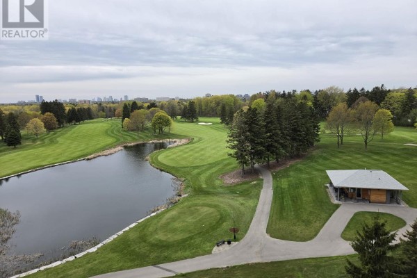 Aerial view of a golf course with a pond and distant city skyline. - 519 - 399 Royal Orchard Boulevard, Markham