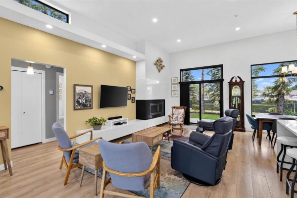 Living room with yellow accent wall, fireplace, television, and contemporary furniture. - 519 Cote Avenue, St Pierre Jolys