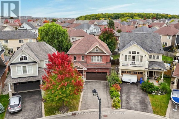 Aerial view of a suburban street lined with houses, showcasing the property from above. - 52 Bardoe Crescent, Milton