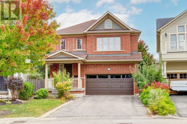 Front exterior of a two-story brick home with a covered porch and attached garage. - 52 Bardoe Crescent, Milton