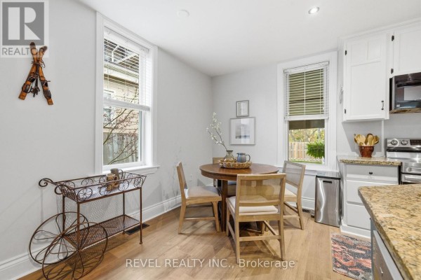 Dining area with table and chairs next to kitchen - 52 Cambridge Street N Kawartha Lakes