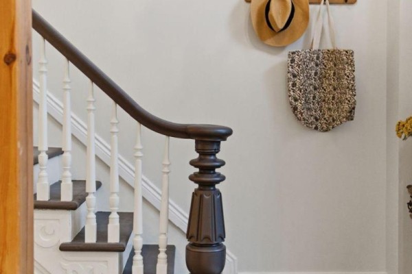 Wooden staircase with ornate balusters, hat rack, and pendant light - 52 Cambridge Street N Kawartha Lakes