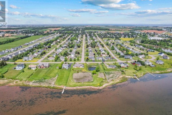 Aerial view of the residential neighborhood showing houses, streets, and waterfront. - 52 Hallie Drive, Summerside