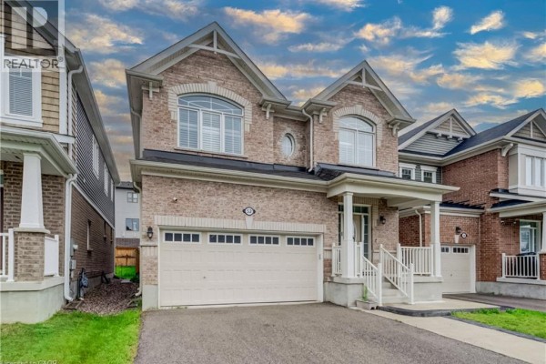 Front exterior of a two-story brick house with a double garage and covered porch. - 52 Pointer Street, Cambridge