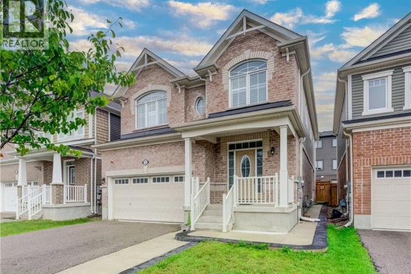 Front exterior of a two-story brick house with a double garage and covered porch. - 52 Pointer Street, Cambridge