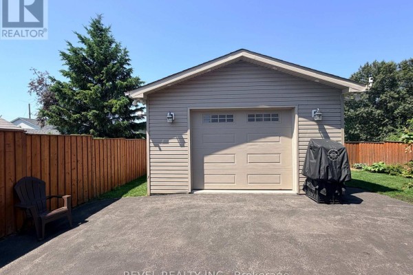 Basement room with a large table, folding chairs, and shelves filled with decorations. - 521 Pine Street N, Timmins