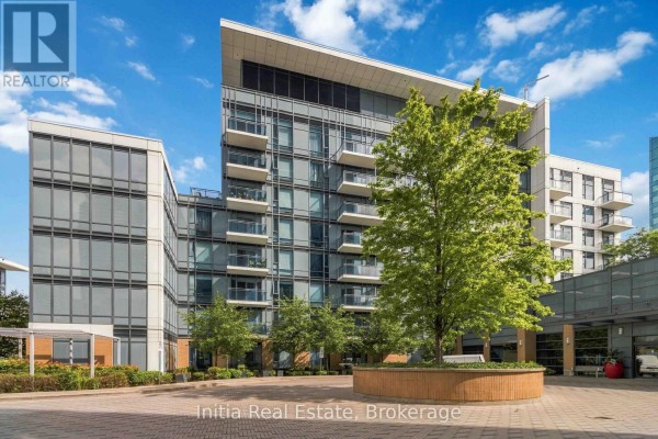 Exterior view of a multi-story condo building with glass windows and balconies. - 522 - 55 Ann O'reilly Ann O'reilly Road, Toronto