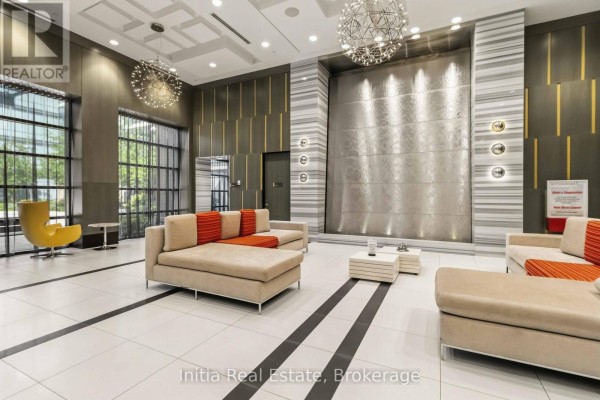 Lobby with modern furniture, a water feature, and artistic light fixtures. - 522 - 55 Ann O'reilly Ann O'reilly Road, Toronto