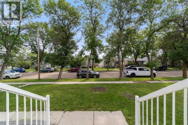 View from the front porch looking down the street at parked cars and houses. - 5224 43 Street, Camrose