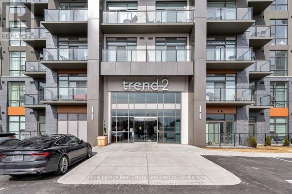 Entrance to "trend 2" building with glass doors and contemporary signage. - 524 - 460 Dundas Street E, Hamilton