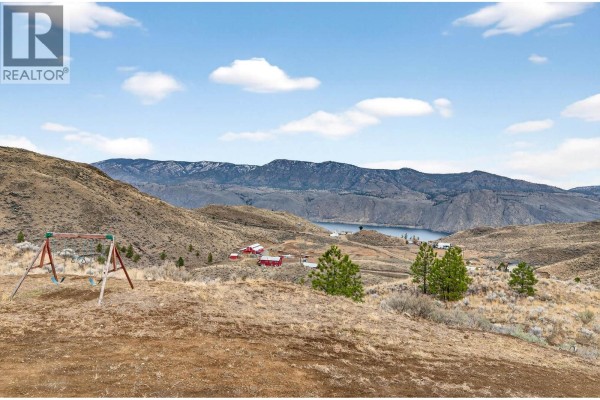 Aerial view of property with surrounding landscape, mountains, and distant lake - 524 Deer Drive, Kamloops