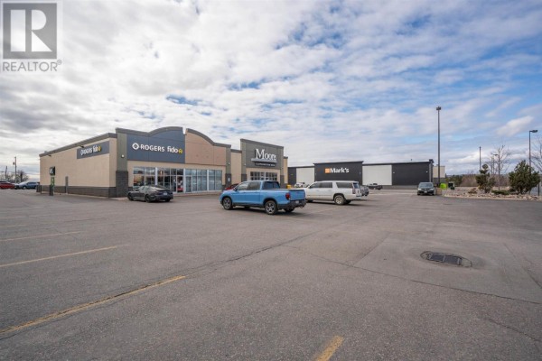 Commercial plaza exterior showing multiple storefronts including Rogers, Fido, Moore's, and Mark's. - 524 Great Northern Rd # 3, Sault Ste  Marie