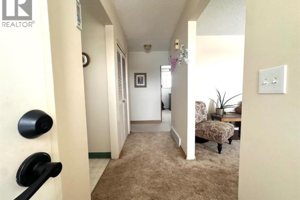 Furnace and hot water tank in unfinished basement with concrete floor. - 5240 50 Avenue, Holden