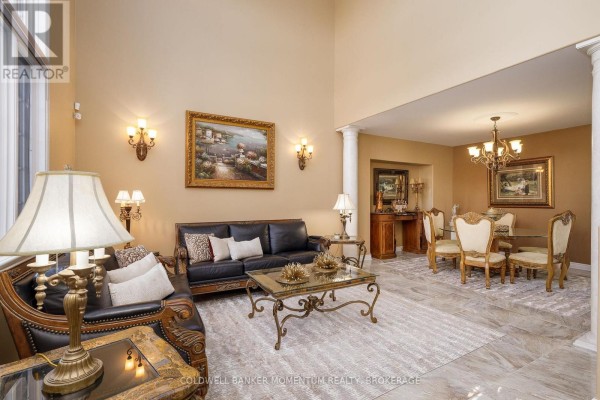 Living room with leather furniture and a formal dining area featuring a glass table and upholstered chairs. - 5246 Marcel Crescent, Niagara Falls