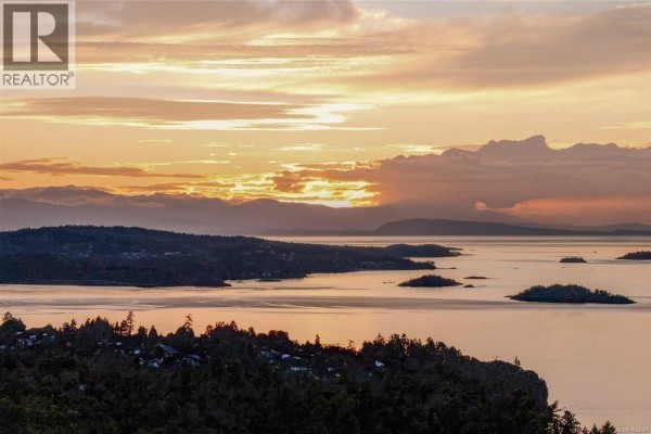 Ocean view with islands and a colorful sunset sky over the water. - 5287 Lost Lake Rd, Nanaimo