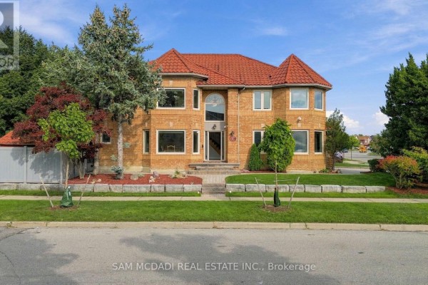 A large brick house with red tile roof and manicured landscaping during the day. - 5289 Fallingbrook Drive, Mississauga