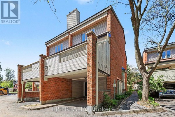 Side view of townhouse units 51 and 53 showing brick exterior and balcony. - 53 - 110 Havelock Street, Ottawa
