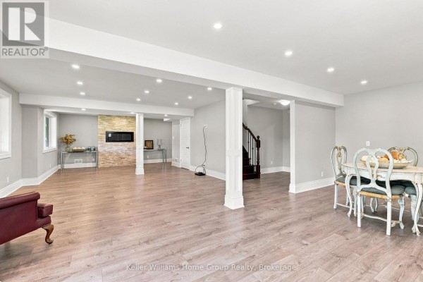 Finished basement with fireplace, dining set, and wood floors - 53 - 145 Aberfoyle Mill Crescent Puslinch