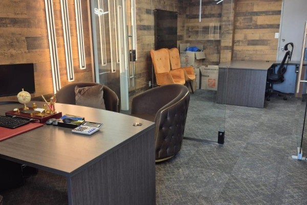 Office space with desks, chairs, and wooden accent walls, viewed from an entrance. - 53 - 2455 Cawthra Street, Mississauga