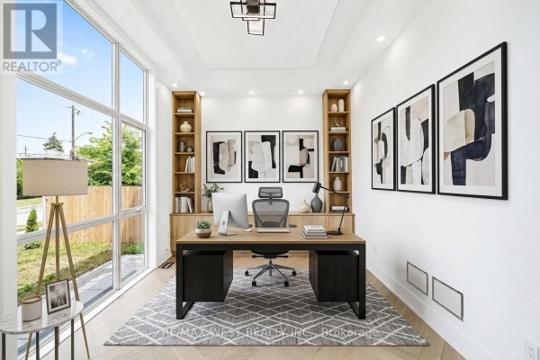 Interior view from the foyer showing a living area with wood floors, built-in shelving, and a fireplace. - 53 Celt Avenue, Toronto