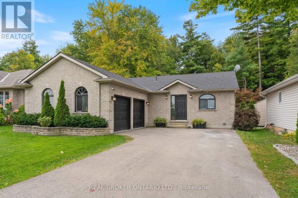 Front exterior of a light brick bungalow with a double garage and a covered entryway. - 53 Hawtrey Road N, Norfolk