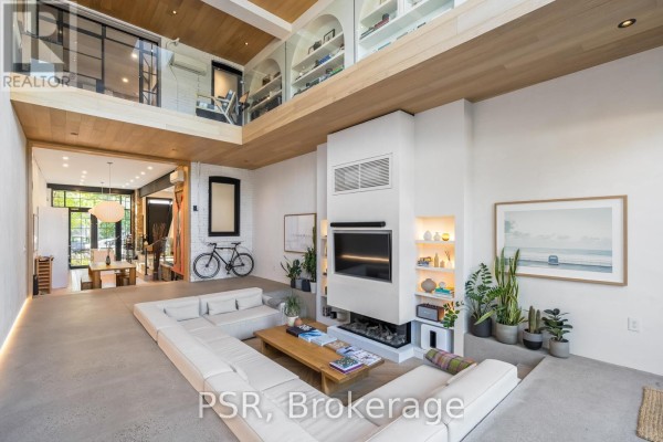 Modern living room with sectional sofa, fireplace, and loft - 53 Palmerston Avenue Toronto