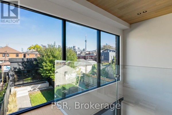 City skyline with CN Tower view through large windows and glass railing - 53 Palmerston Avenue Toronto