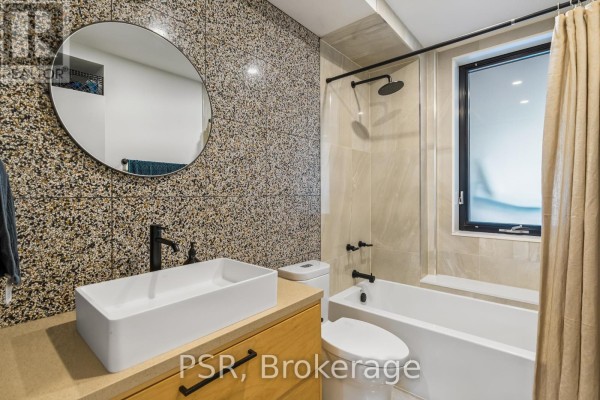 Bathroom with vessel sink, speckle tile, and bathtub - 53 Palmerston Avenue Toronto