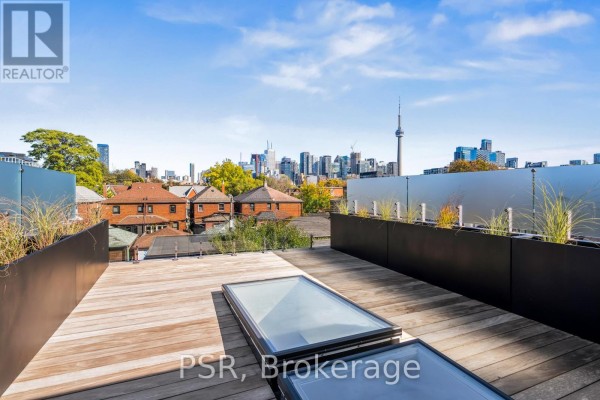 Wooden deck with skylights and city skyline view - 53 Palmerston Avenue Toronto