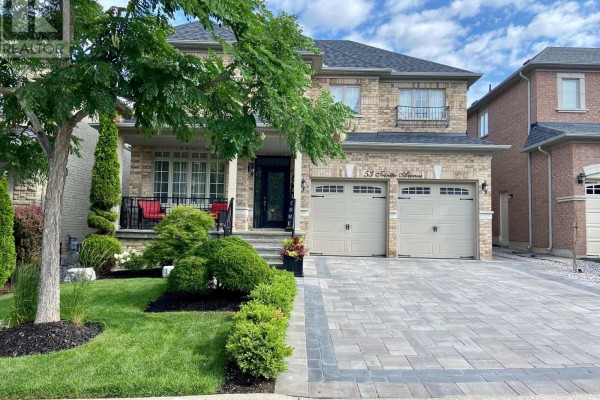 Front view of a two-story brick house featuring a double garage, stone accents, and lush green lawn. - 53 Trinita Avenue, Vaughan