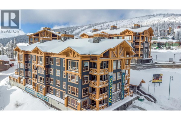 Exterior view of Stonegate condo buildings with balconies and snow-covered roofs. - 5300 Big White Road Unit# 105, Big White