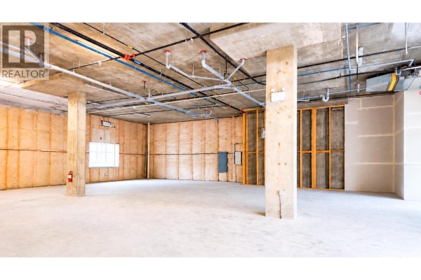 Unfinished commercial space with concrete floors, exposed ceiling pipes, and insulated walls. - 5300 Main Street Unit# 40 & 50, Kelowna