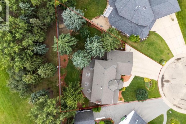 Overhead view of a residential property showcasing the house, surrounding trees, and lot lines. - 5302 61 Street Close, Camrose