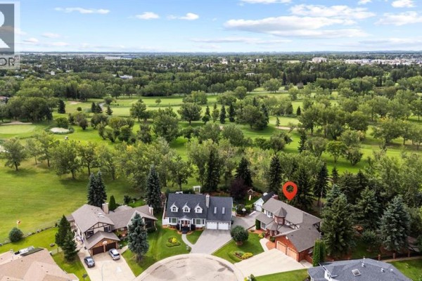 Aerial view of houses on a cul-de-sac with a golf course in the background. - 5302 61 Street Close, Camrose